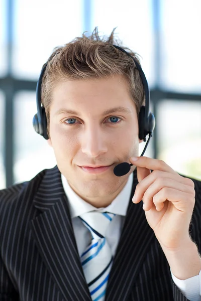 Handsome oung businessman with a headset on — Stock Photo, Image