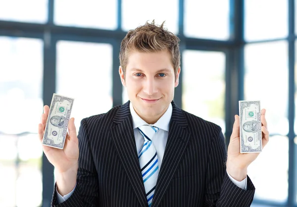 Attractive businessman holding dollars — Stock Photo, Image