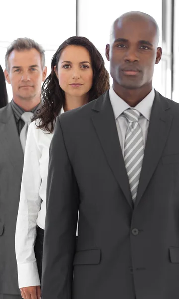 Serious Business man looking at camera with group in background — Stock Photo, Image