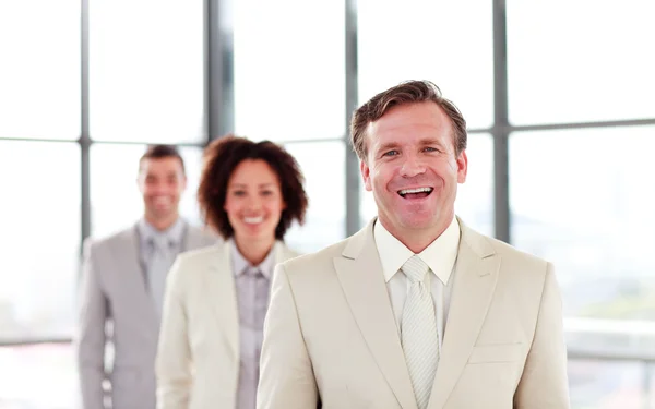 Smiling mature businessman leading a team — Stock Photo, Image