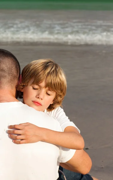 stock image Son and father hugging on the beach