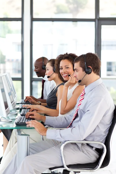 Smiling African-American businesswoman working in a call center — Stock Photo, Image