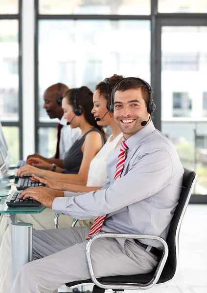 Friendly businessman working in a call center — Stock Photo, Image