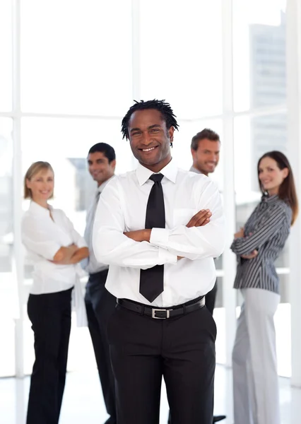 Portrait of an ethnic male leader with his team in background — Stock Photo, Image