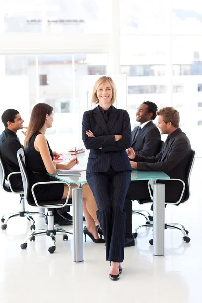 Friendly businesswoman smiling at the camera in a meeting — Stock Photo, Image