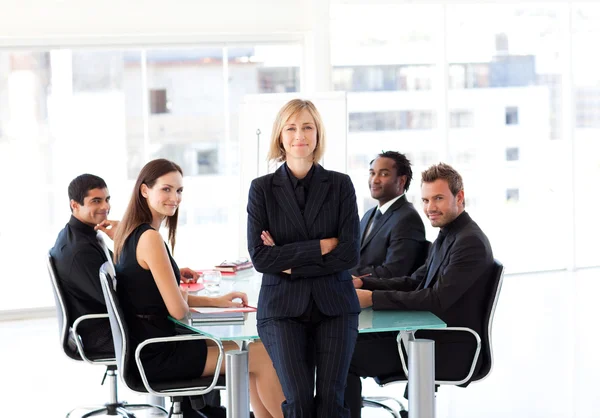 Business team smiling at the camera in an office — Stock Photo, Image