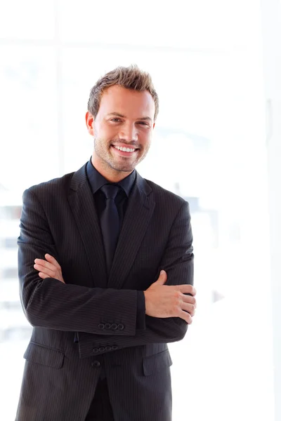 Handsome smiling businessman with folded arms — Stock Photo, Image