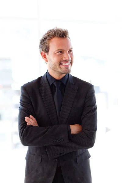 Smiling young businessman with folded arms — Stock Photo, Image