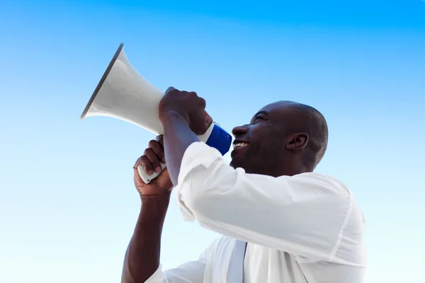 Businessman shouting in a megaphone — Stock Photo, Image