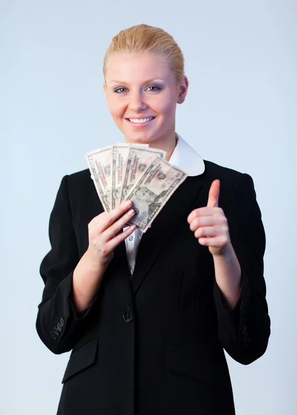 Frau hält Dollars mit erhobenem Daumen Stockfoto