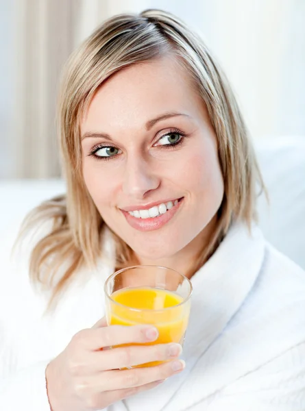 Portrait of a charming woman holding an orange juice Stock Photo