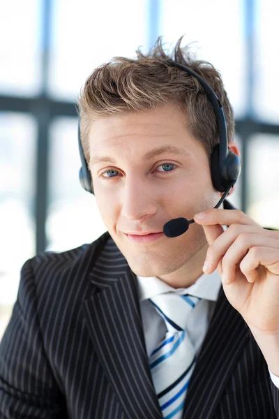Young businessman with a headset on in a call center Royalty Free Stock Photos