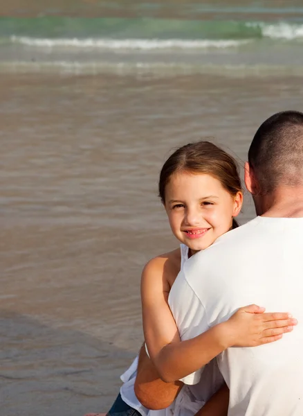 Daughter and her father hugging on the beach Royalty Free Stock Photos