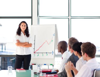 Confident businesswoman in a presentation with folded arms clipart