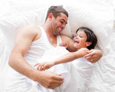 Father and Son Lying on bed and sleeping clipart