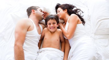 Smiling son with his parents sleeping clipart