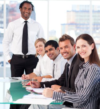 Happy business leader with his team in a meeting clipart