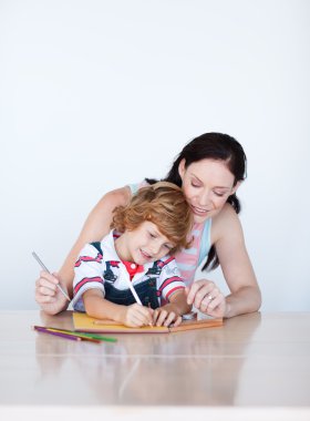 Mother and son doing homework with copy-space clipart