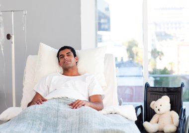 Hispanic patient resting in bed clipart