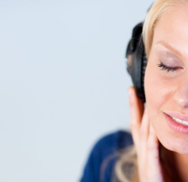 Relaxed woman listening music with headphones clipart