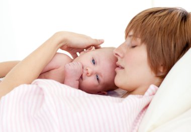 Mother sleeping with her newborn baby clipart