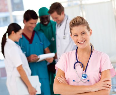 Nurse with doctors in the background clipart