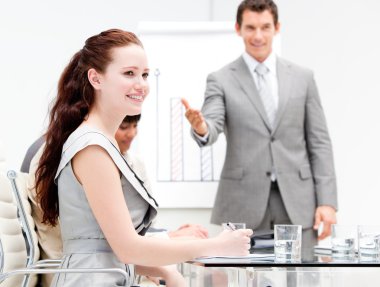 Portrait of a concentrated businesswoman during a meeting clipart