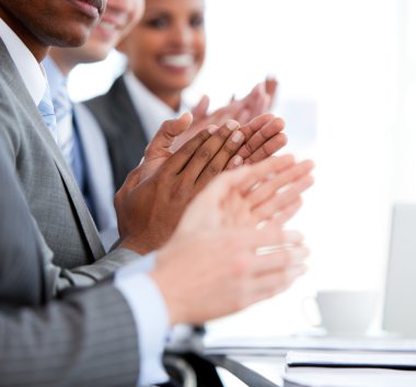 Close up of a mixed business team applauding a presentation clipart