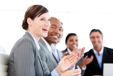 Portrait of smiling businessteam applauding a presentation clipart