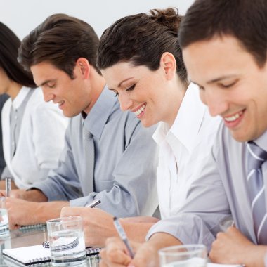 Young business taking notes at a conference clipart