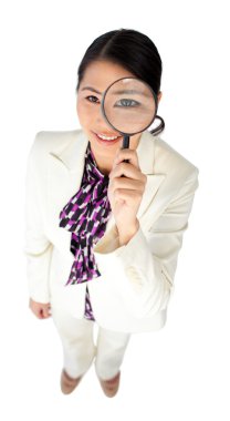 Young Asian businesswoman looking through a magnifying glass clipart