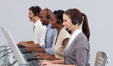 Positive business partners working in a call center clipart