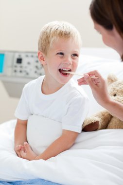 Female doctor checking her patient's throat clipart