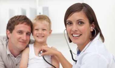 Smiling doctor checking her patient's pulse clipart