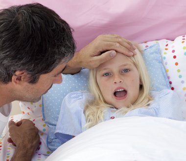 Father checking his daughter's temperature clipart