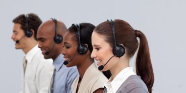 Multi-ethnic young business partners working in a call center clipart