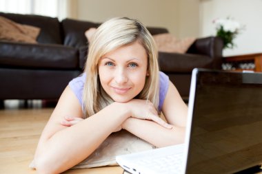 Bright woman using a laptop clipart