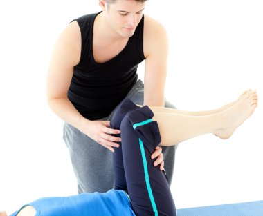 Caucasian woman exercising assited by her personal trainer clipart