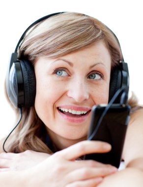 Portrait of a charming woman listening the music with headphone clipart