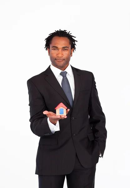 Friendly businessman holding a house — Stock Photo, Image