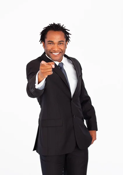 Smiling businessman pointing at the camera — Stockfoto