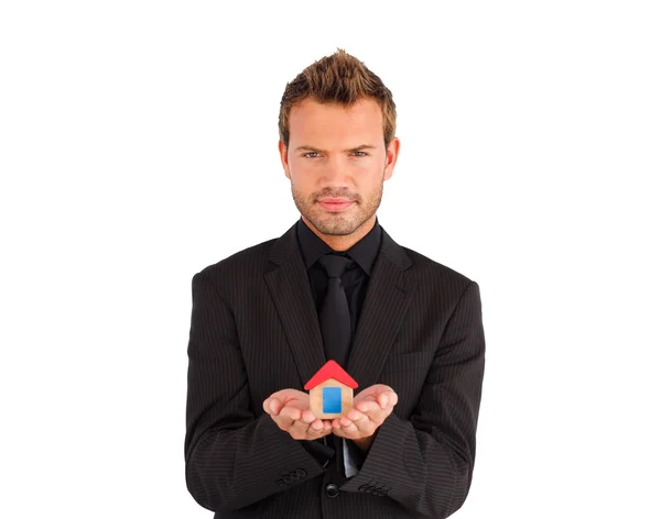 Young businessman presenting a sample of house — Stock Photo, Image