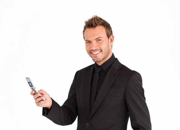 Giovane uomo d'affari sms e sorridente alla fotocamera — Foto Stock
