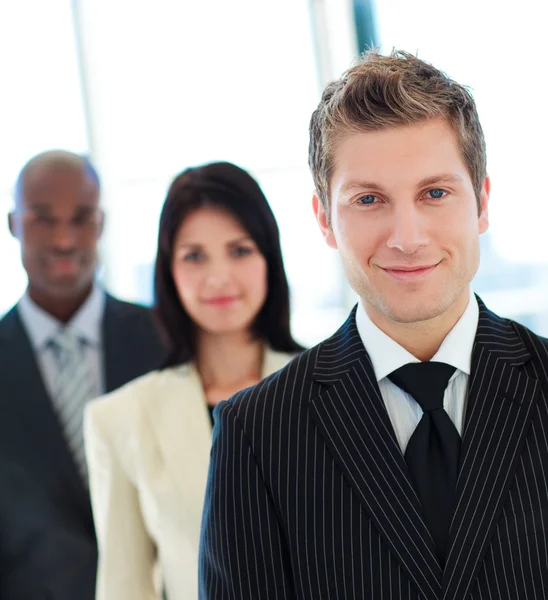 Friendly businessman in front of his team — Stock Photo, Image