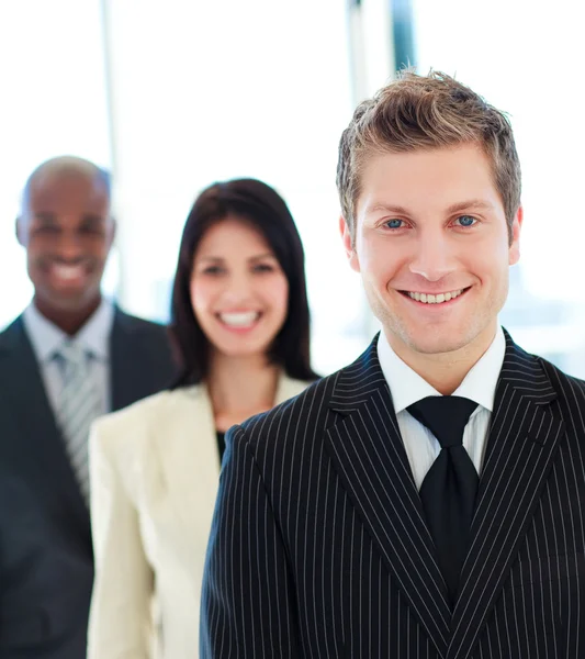 Smiling businessman in front of his team — Stock Photo, Image