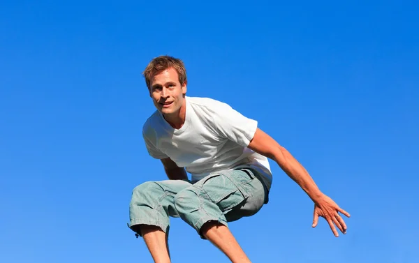 Genç adam havaya zıplıyor. — Stok fotoğraf