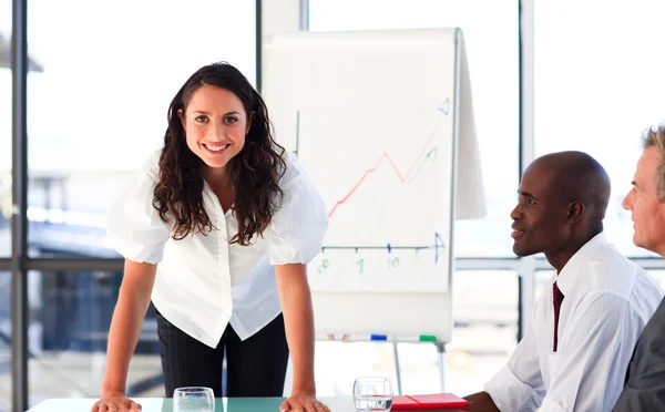 Confident businesswoman smiling at the camera in a meeting — Stock Photo, Image