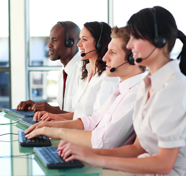 Smiling young with a headset on working — Stock Photo, Image