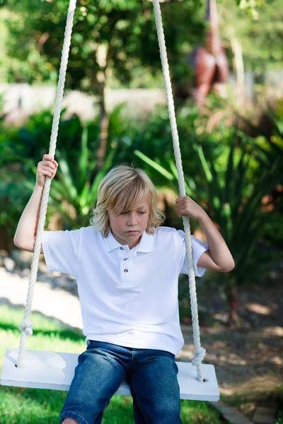Kid having fun on a swing — Stock Photo, Image