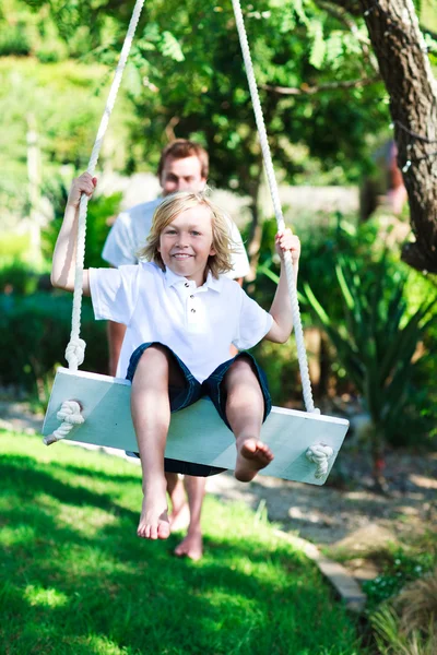 Dad and kid having fun swinging together — Stock Photo, Image